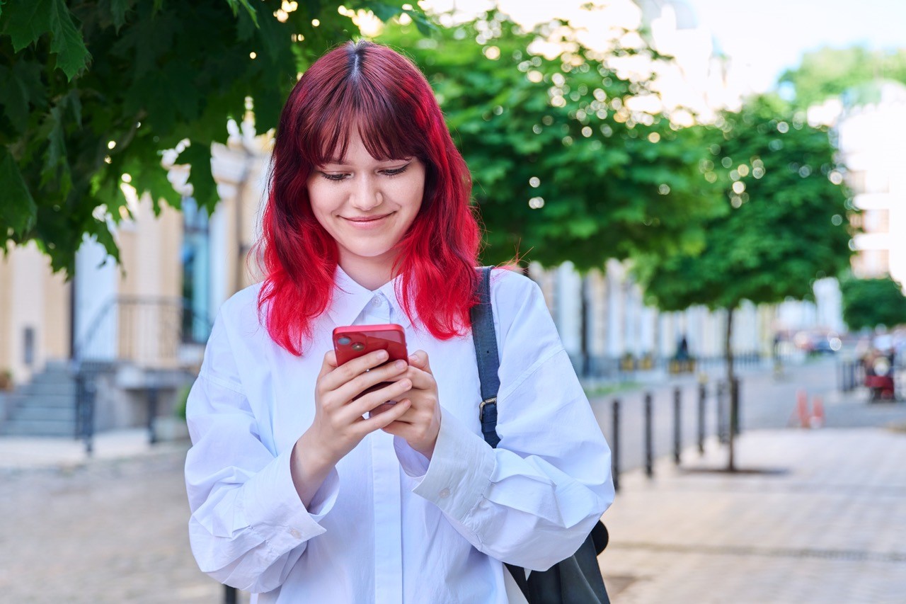 lady holding and looking at her smartphone