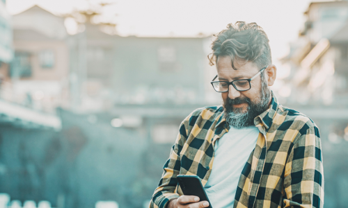 Mature man looking at phone